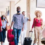 Group of young adults at a train station traveling in Italy - Basic Italian Phrases for Traveling to Italy