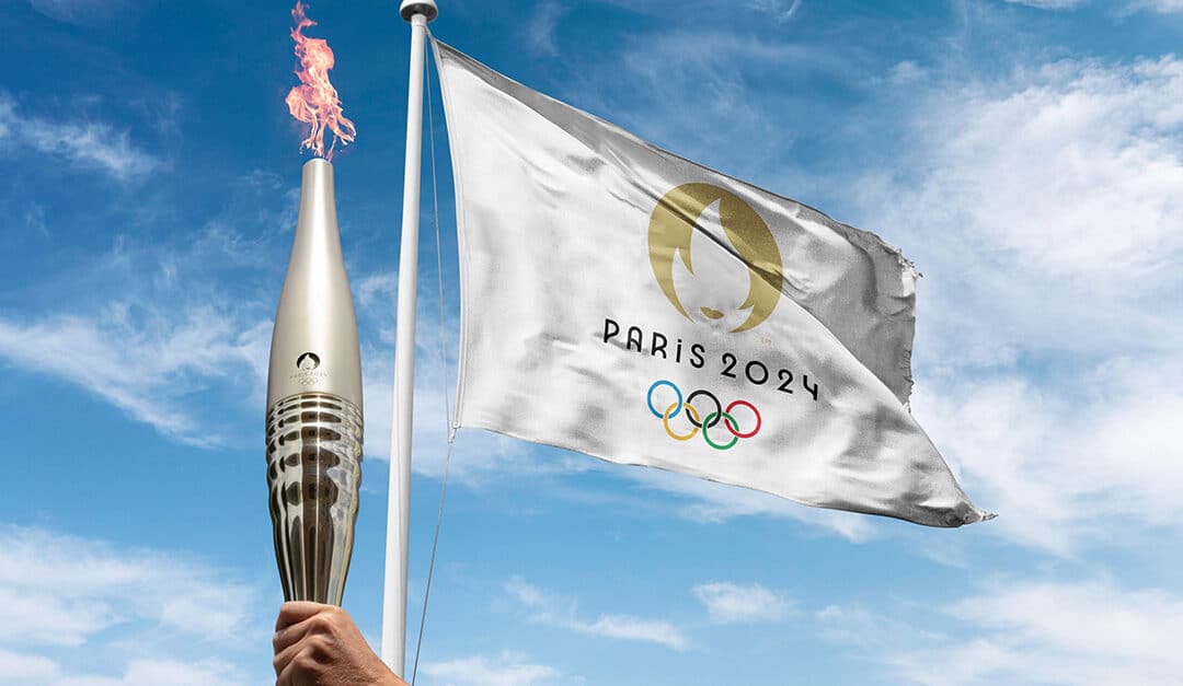 Paris, France 2024 Olympics flag waving at cloudy sky background. with the olympics flame holding by athlete.