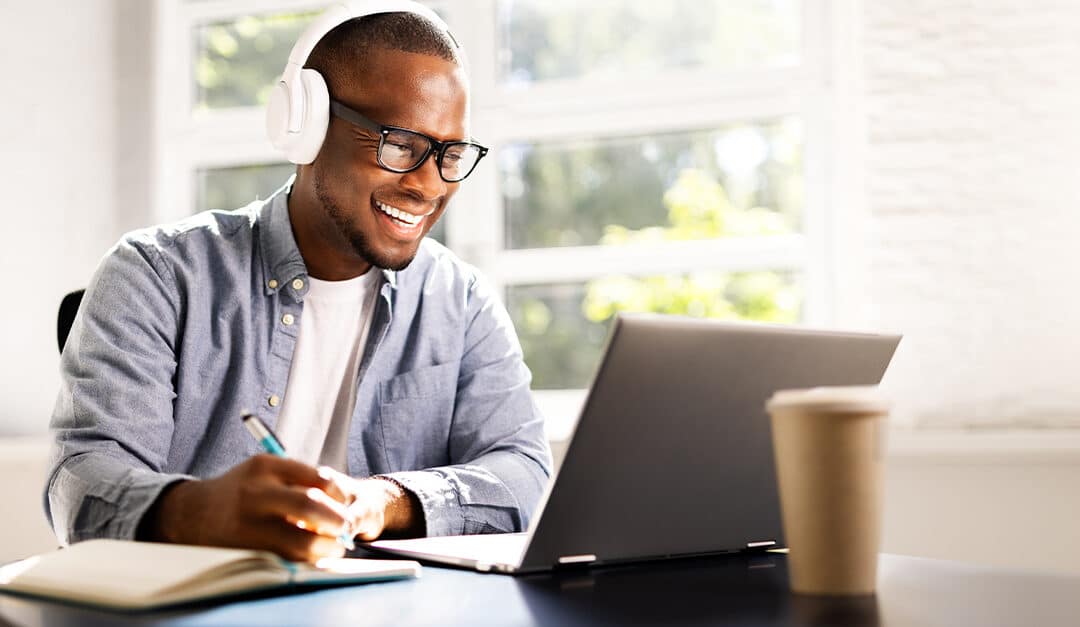 Young African American man learning Spanish online with a professional tutor