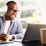 Young African American man learning Spanish online with a professional tutor
