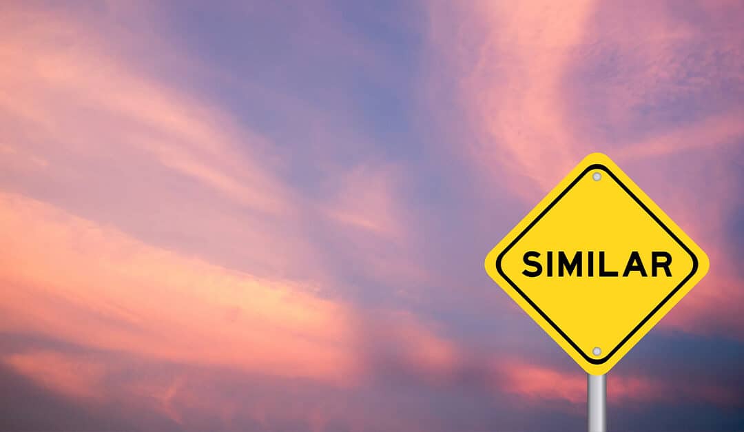 Yellow transportation sign with word similar on violet color sky background, illustrating the blog topic "Near-Perfect Cognates in English and Spanish"