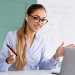 Female English tutor teaching online through her laptop, illustrating the blog topic "How to Find the Best English Tutor Near Me"